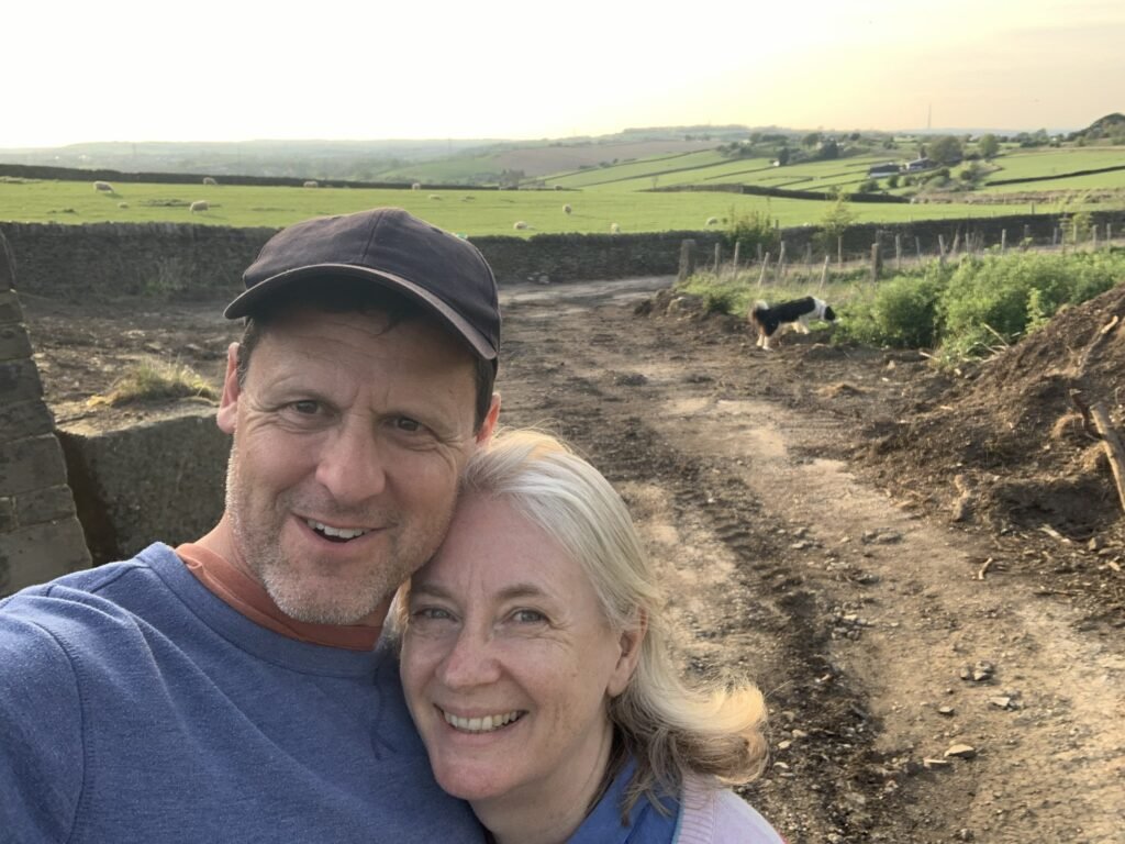 Chris and Helen clearing the new access at Copster Barn, with their dog behind them